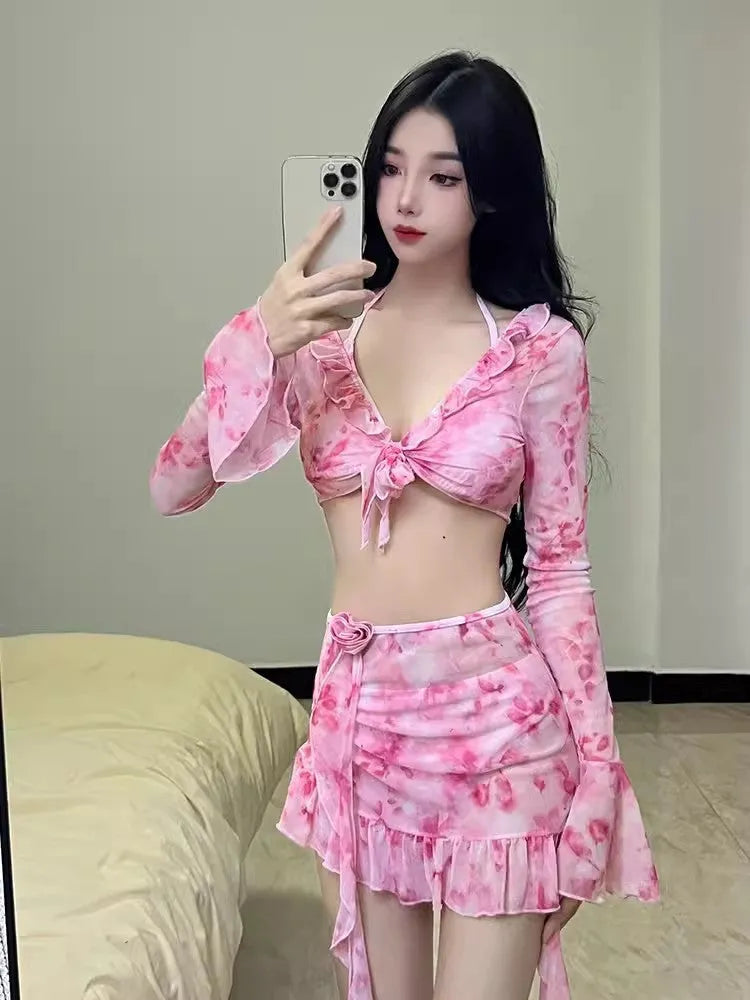 Women's cherry blossom pink floral bikini swimsuit laid flat, showing the pattern and style.