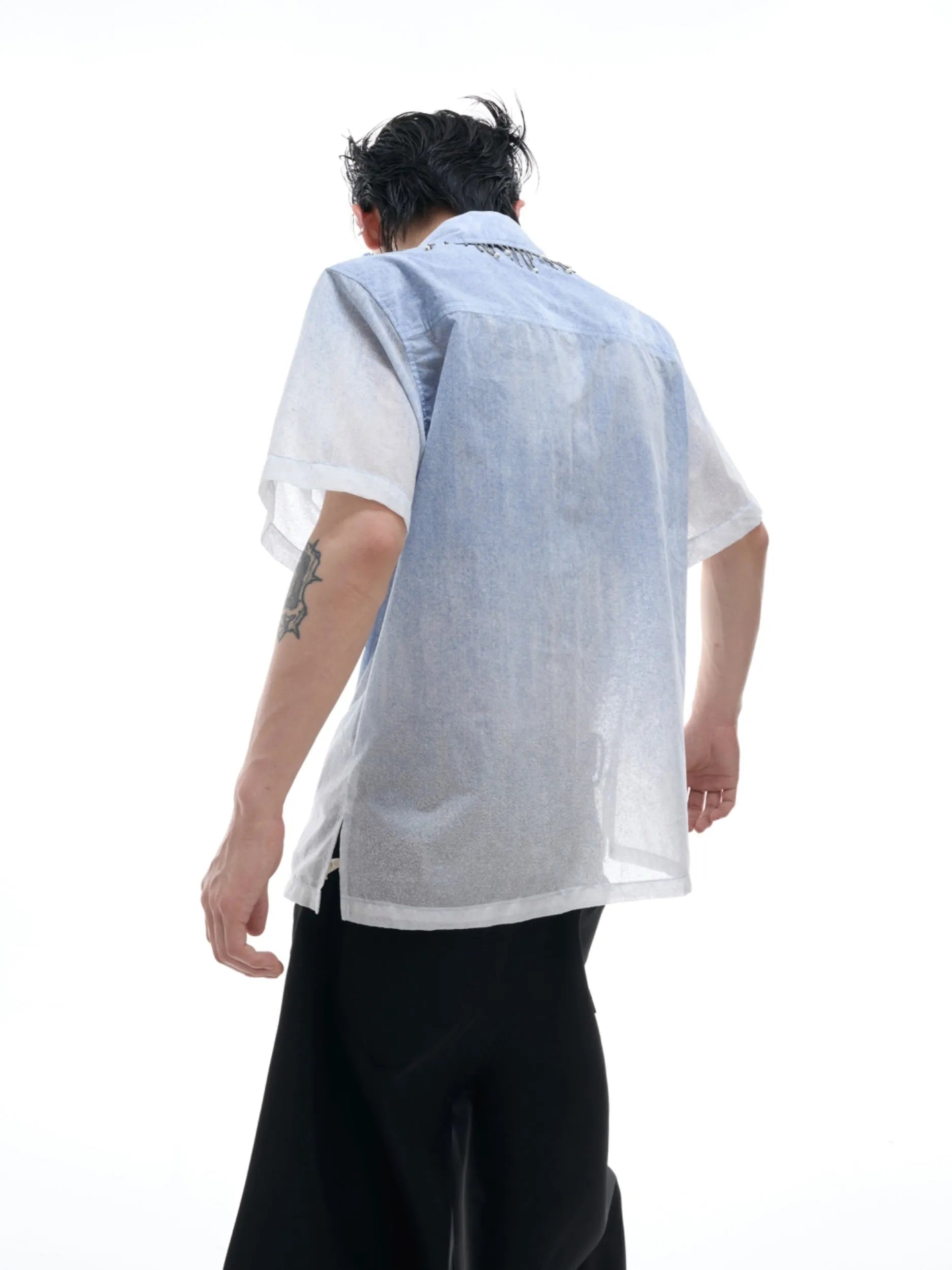 A blue and white gradient loose short-sleeve shirt on a hanger.