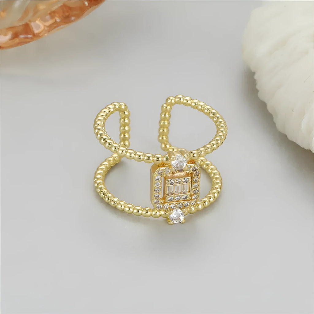 Gold-plated copper open ring with U-shape, adjustable opening, and asymmetrical design.