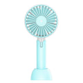 Blue handheld mini USB electric fan with three-speed control on a desktop.