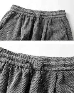 Plus size black straight-leg trousers with hollow-out design and elastic waistband laid flat.