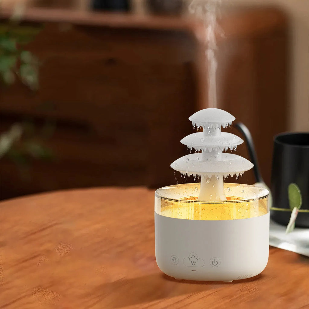 White cloud rain humidifier and essential oil diffuser with LED mood lighting on table