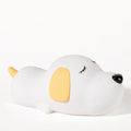 Cute two-colour silicone cartoon dog USB rechargeable night lamp on a surface.