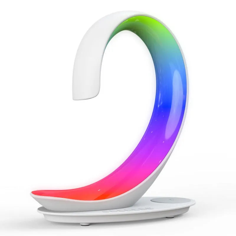 White swan-shaped desk lamp with wireless charging pad and Bluetooth speaker providing colourful ambient lighting
