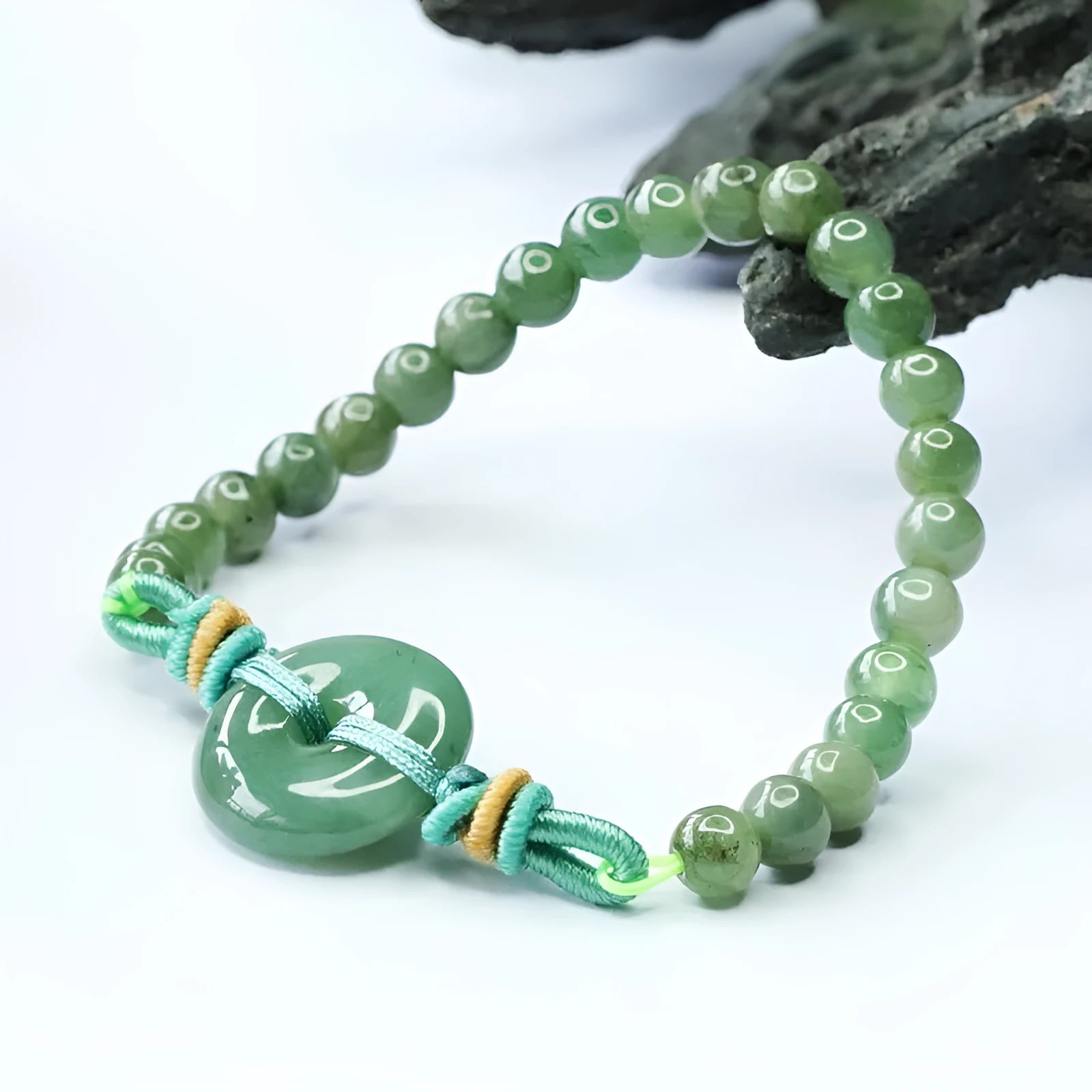 Oil green jade bracelet with star-shaped beads and a silver safety buckle clasp.