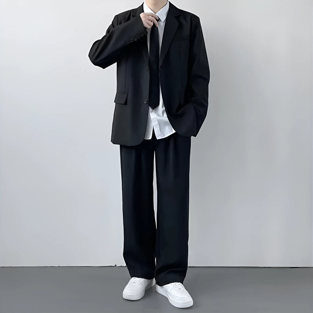 Plus size men in a navy college style suit set with white shirt and tie, showing loose fit.