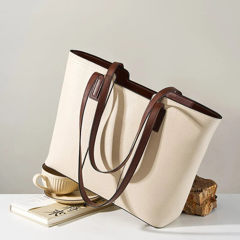 Women's black genuine leather crossbody bag with square shape and single shoulder strap.