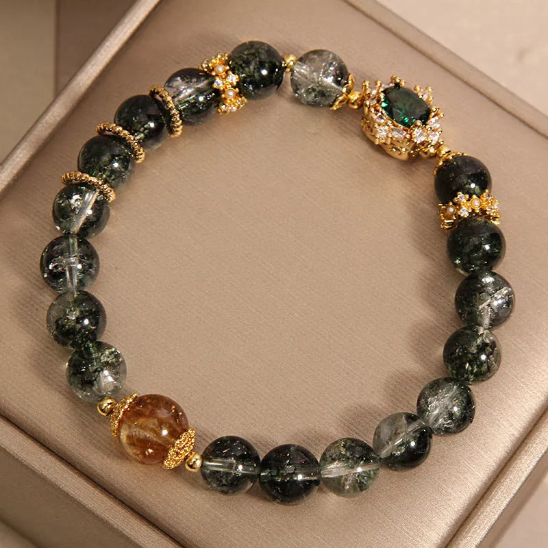 Women's crystal bracelet with gold rutilated quartz, green phantom quartz, and ruby quartz gemstones