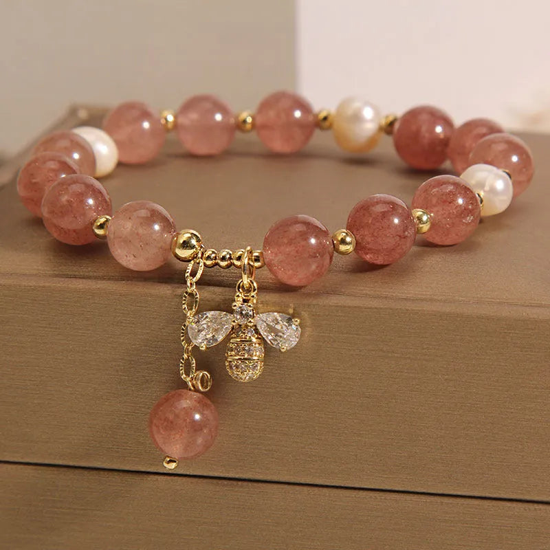Women's bracelet with strawberry quartz beads, freshwater pearls, and metallic charms in Japanese Korean jewellery style