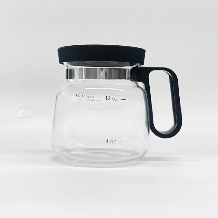 Transparent borosilicate glass coffee maker with black silicone cover on a stovetop