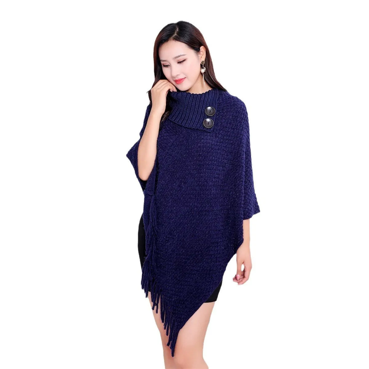 Sleeveless dotted-pattern cloak shawl in acrylic knitwear, shown in apricot colour.