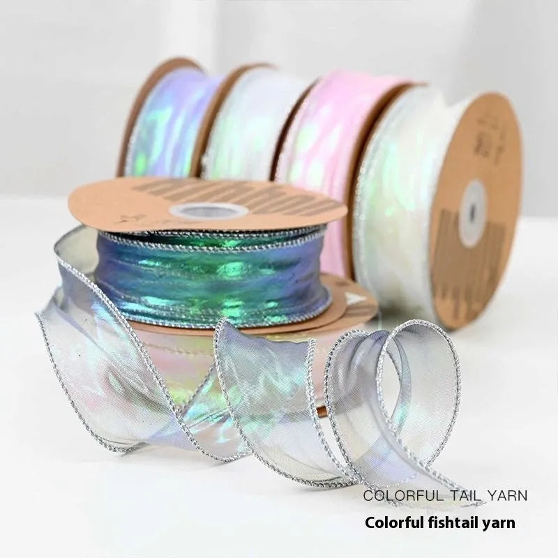 Roll of colourful fishtail yarn mesh ribbon with wave texture, shown in 4cm width.