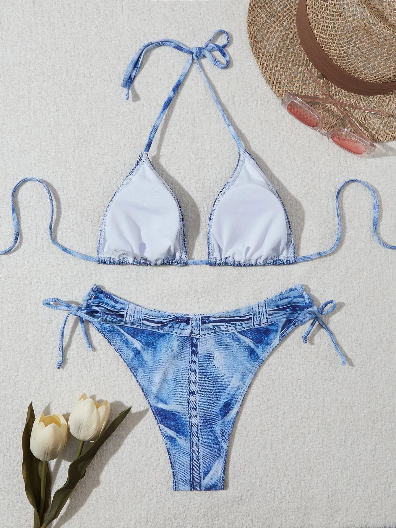 Denim blue printed women's bikini swimsuit with adjustable straps laid flat.