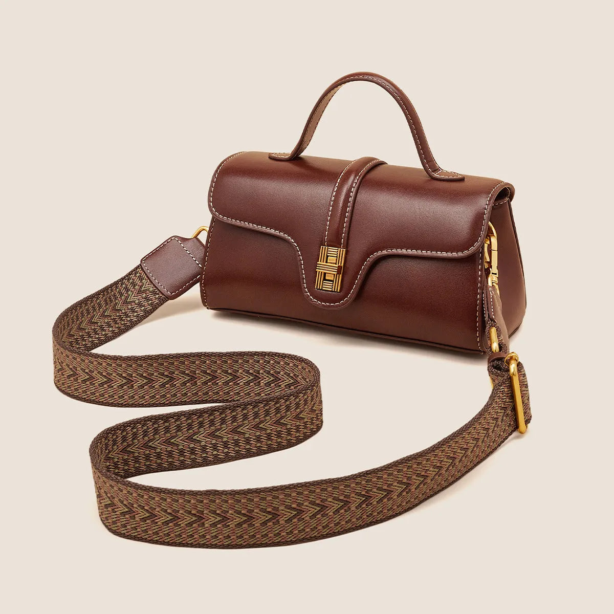 Brown Cambridge leather messenger bag with lock closure showing clamshell opening and internal organisers