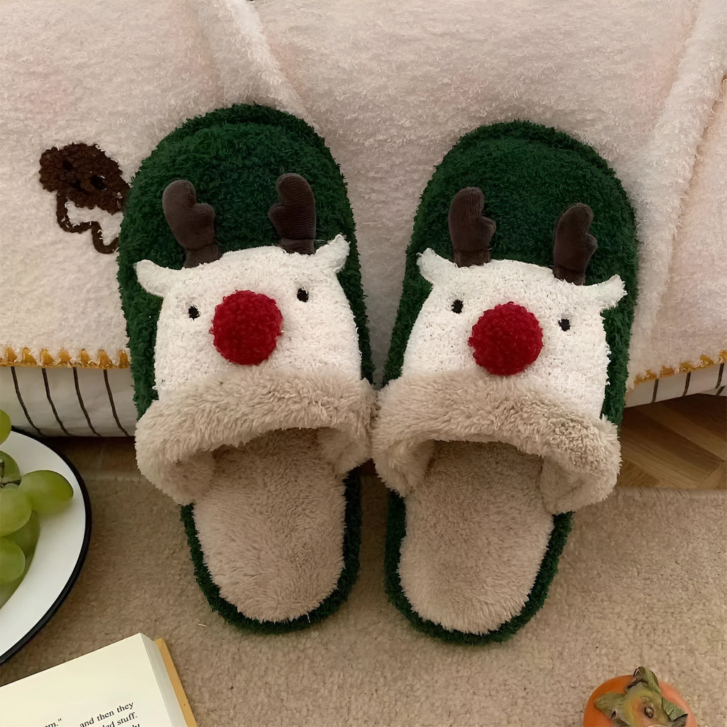 Women's brown Christmas elk plush slippers with non-slip PVC sole on a wooden floor.