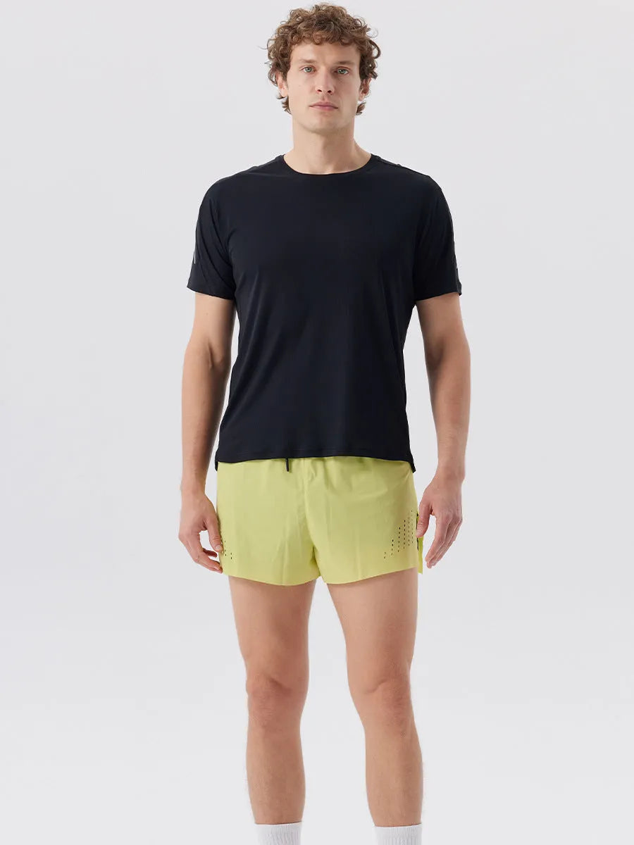 Man wearing black side-slit nylon sports shorts on a casual summer day.
