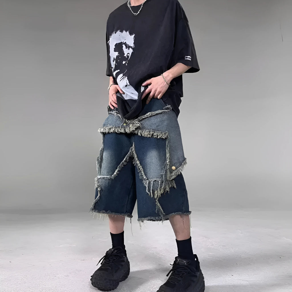 Blue denim shorts with a frayed hem and a large five-pointed star design on the leg, shown on a model.
