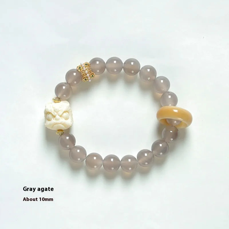 Hand-woven grey agate bracelet with 10mm round beads and mellite decorative accents.