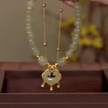 Green women's safety lock bell pendant bracelet with electroplated finish and double-layer construction