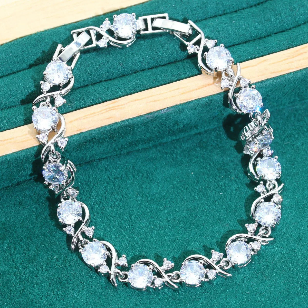 Four-piece bridal jewellery set with zircon chain necklace, bracelet, earrings and ring in alloy with water wave design