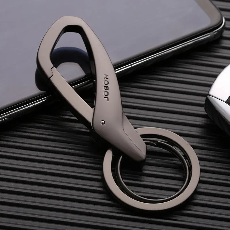 Zinc alloy double ring keychain in black, chrome, or nickel colour, shown with dimensions 8.3 by 3.5 cm.