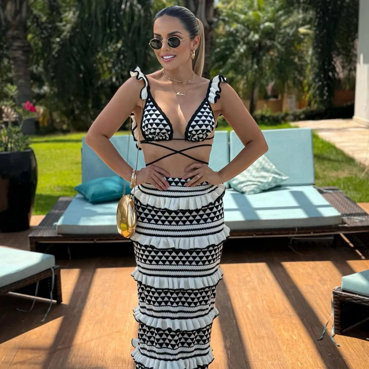 Women's black and white striped bikini set with ruffled spaghetti strap top and long knitted skirt