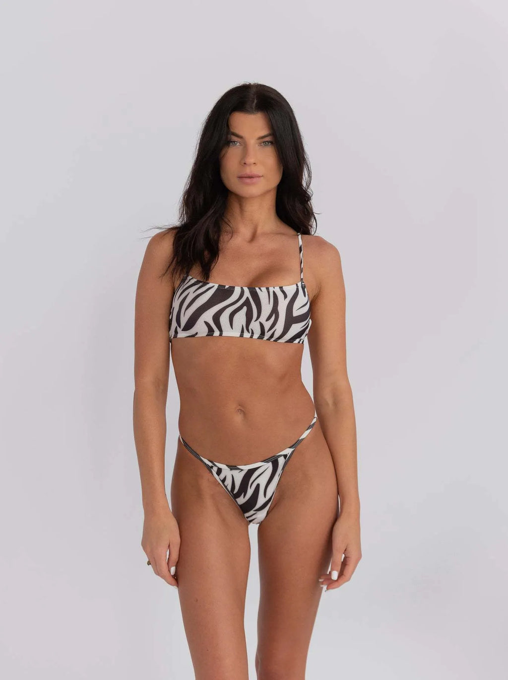 Women's striped banded bikini swimsuit with adjustable straps in breathable polyester fabric.