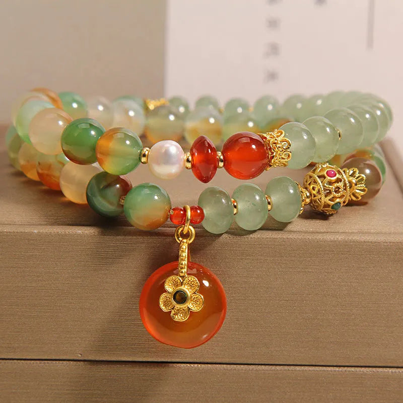 Peacock green agate double ring bracelet for women with safety buckle closure on wrist.