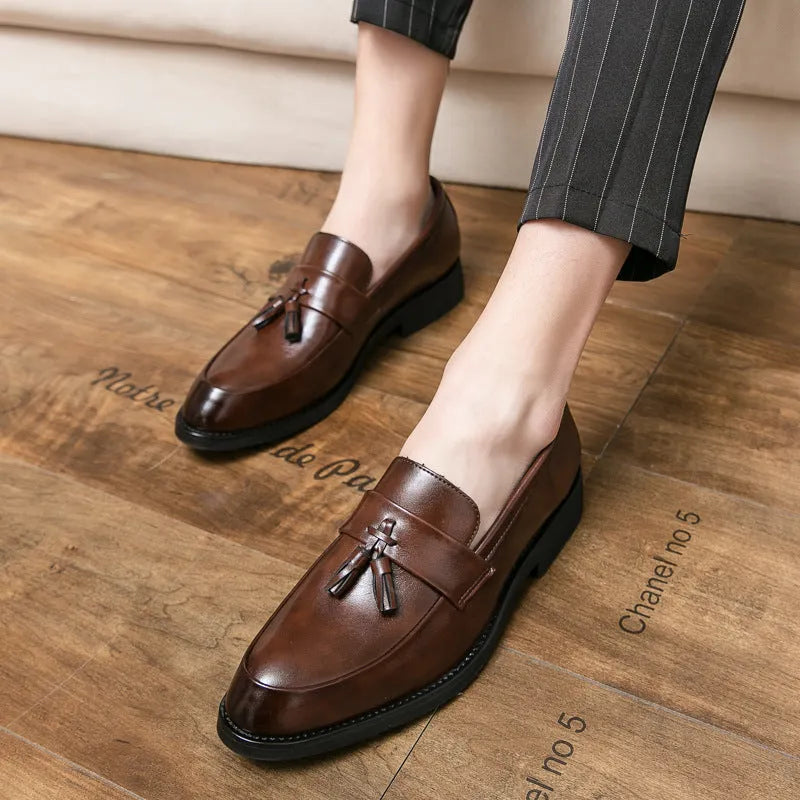 Men's black slip-on business casual shoes with tassel detailing and rubber sole