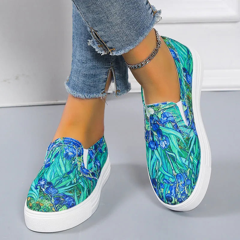 Women's blue colour match canvas trainers with flat rubber sole on a white background.