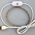 Flexible silicone USB LED light strip bent into a curve, showing touch control button and 3M adhesive backing.