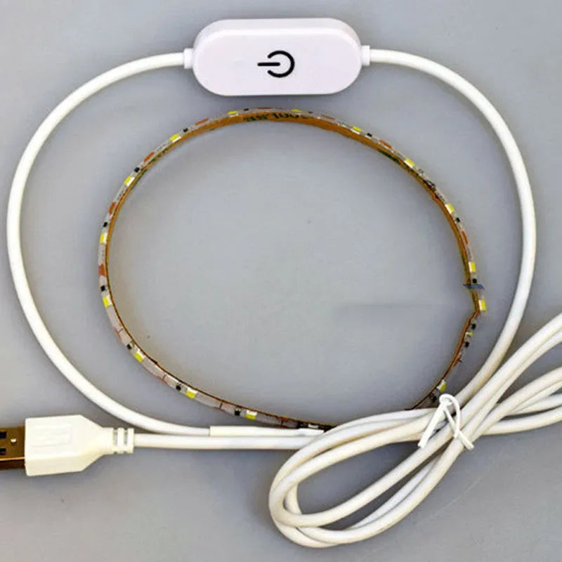 Flexible silicone USB LED light strip bent into a curve, showing touch control button and 3M adhesive backing.