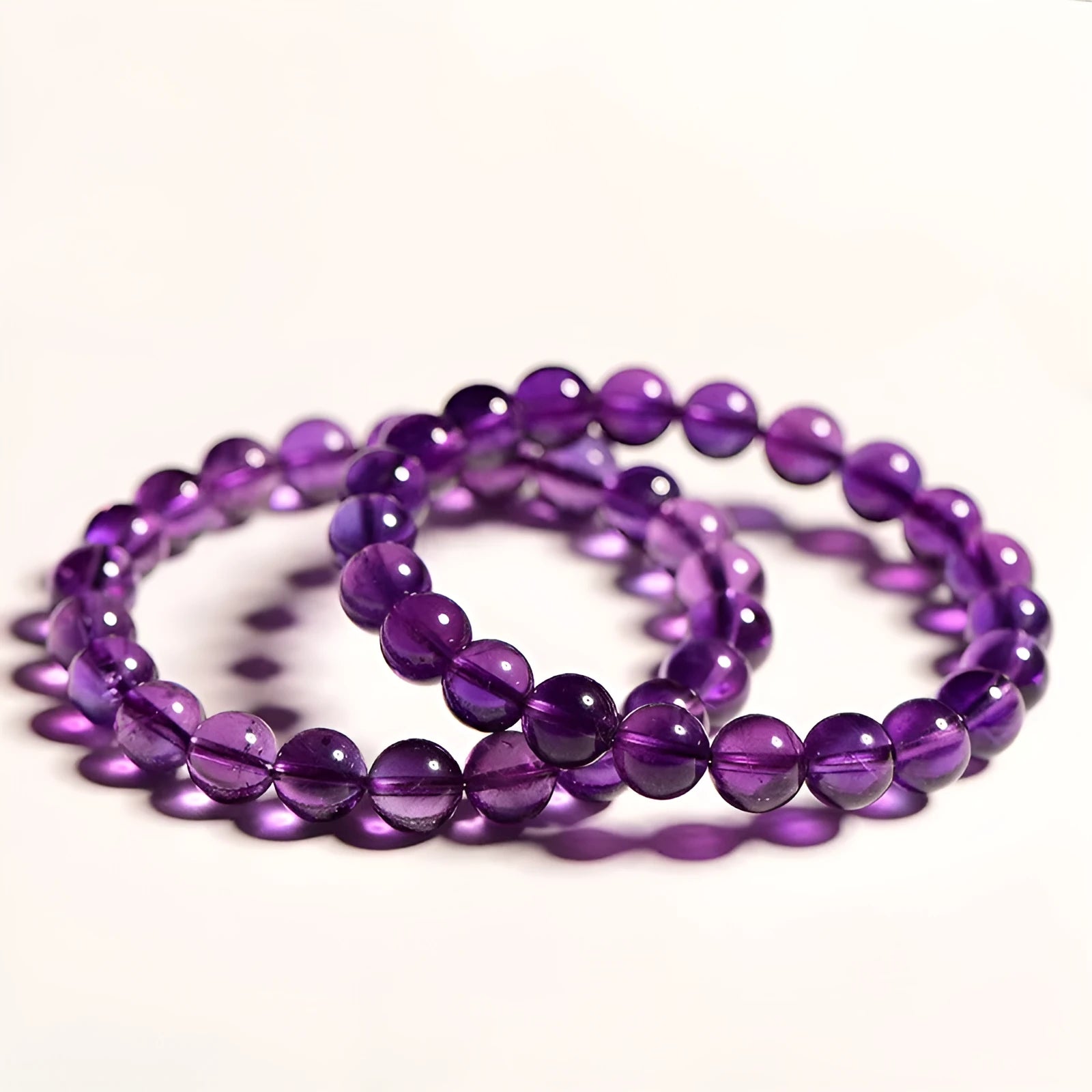 Natural amethyst scattered beads Uruguay bracelet in polished crystal on a white background.