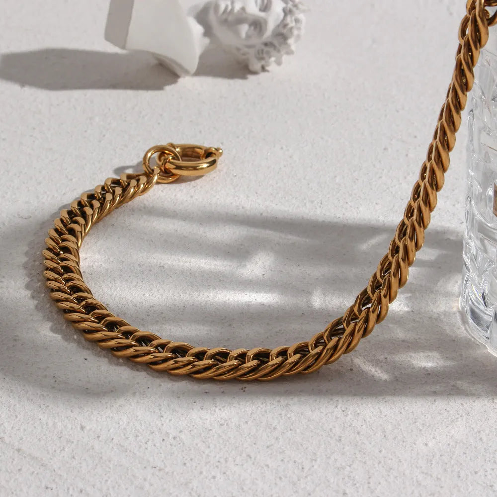 Stainless steel 18K plated gold clavicle necklace with thick encrypted chain and OT buckle on white background