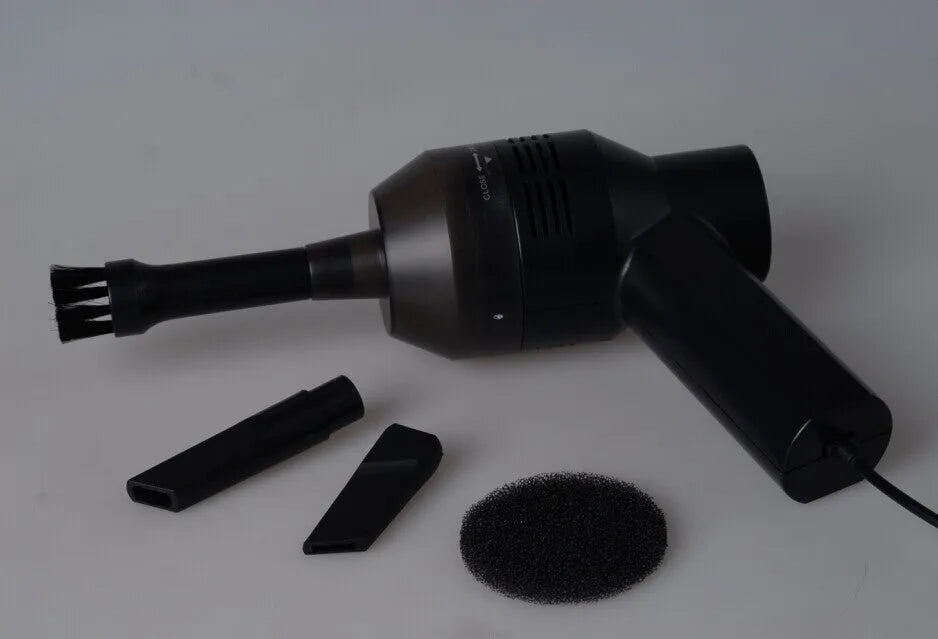 Black handheld desktop mini vacuum cleaner for cleaning keyboards and cars.