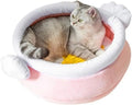 A pink magic honey pot shaped cat sofa bed with a soft interior for a small pet.