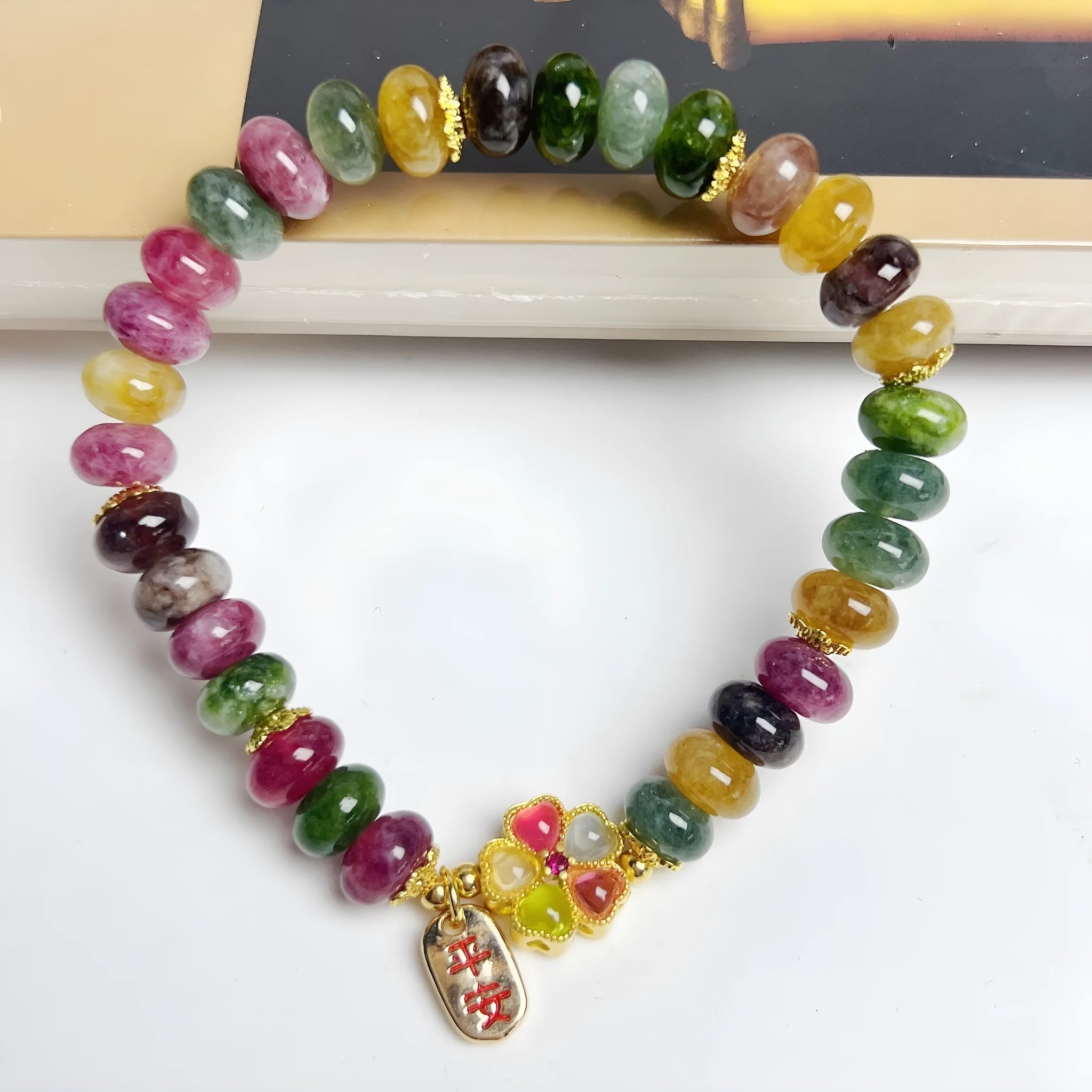 Colourful artificial crystal abacus bead bracelet with tourmaline-style stones on wrist