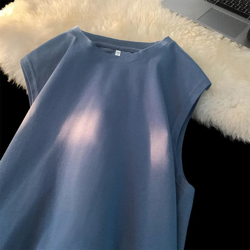 Men's loose apricot-coloured cotton tank top on a hanger.