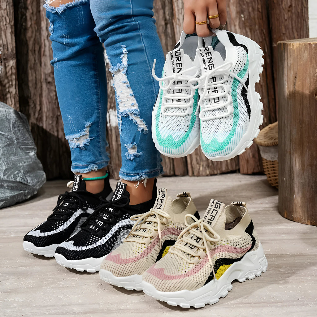 Women's casual sports shoes with mesh upper and front lace-up in black and white colour