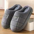 Grey and brown plaid men's winter slippers with thick sole and wool lining.