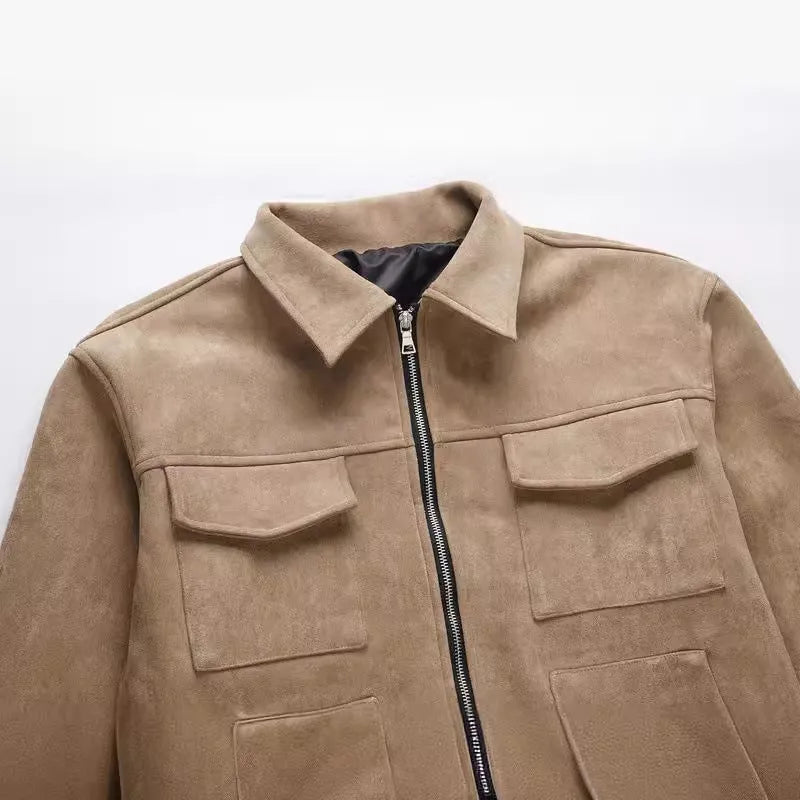 Slim fit camel coloured jacket with zipper pockets on a model.