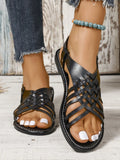 Flat buckle open toe Roman style beach slippers in black with cross straps and hollow out sole