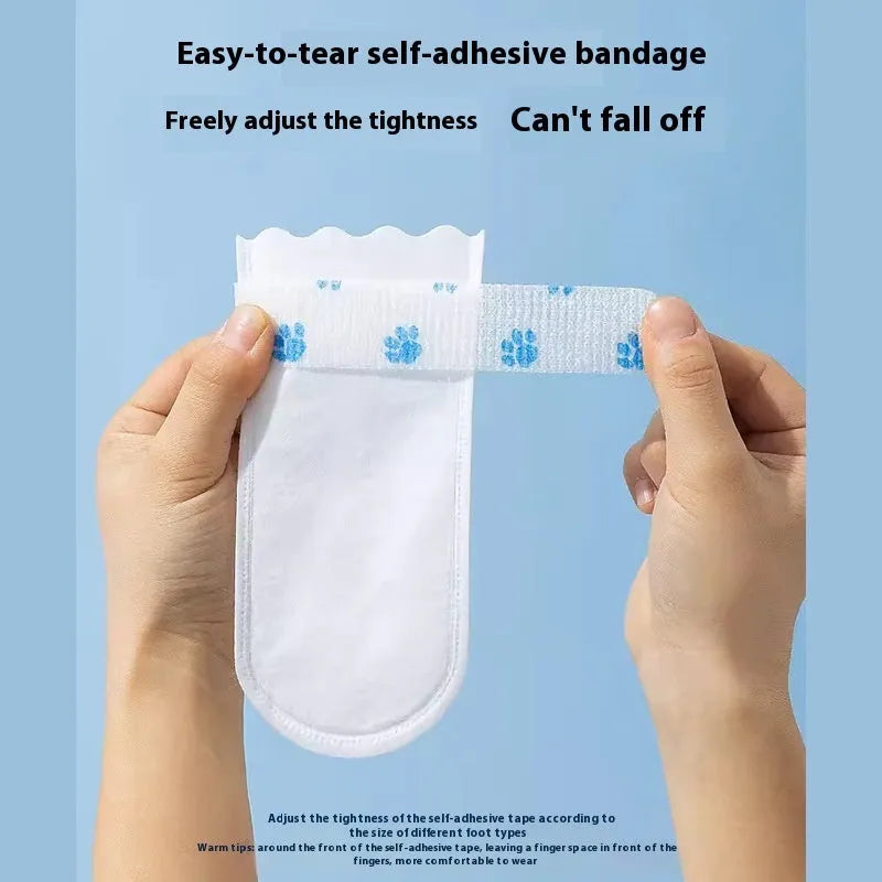 A pack of 20 white disposable non-woven fabric shoe covers for small or medium dogs on a blue background.