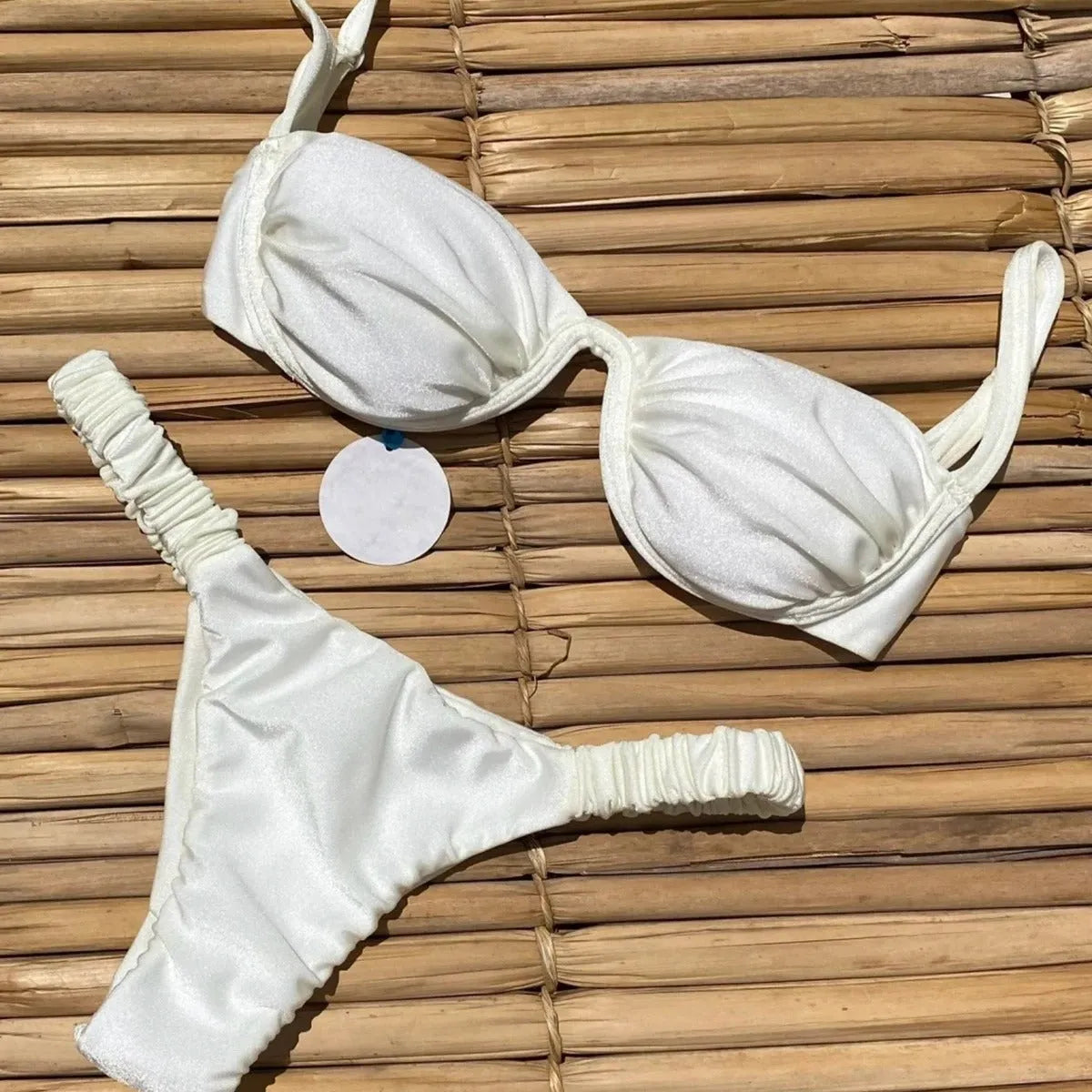 Women's khaki underwire bikini swimsuit with split briefs on a white background.