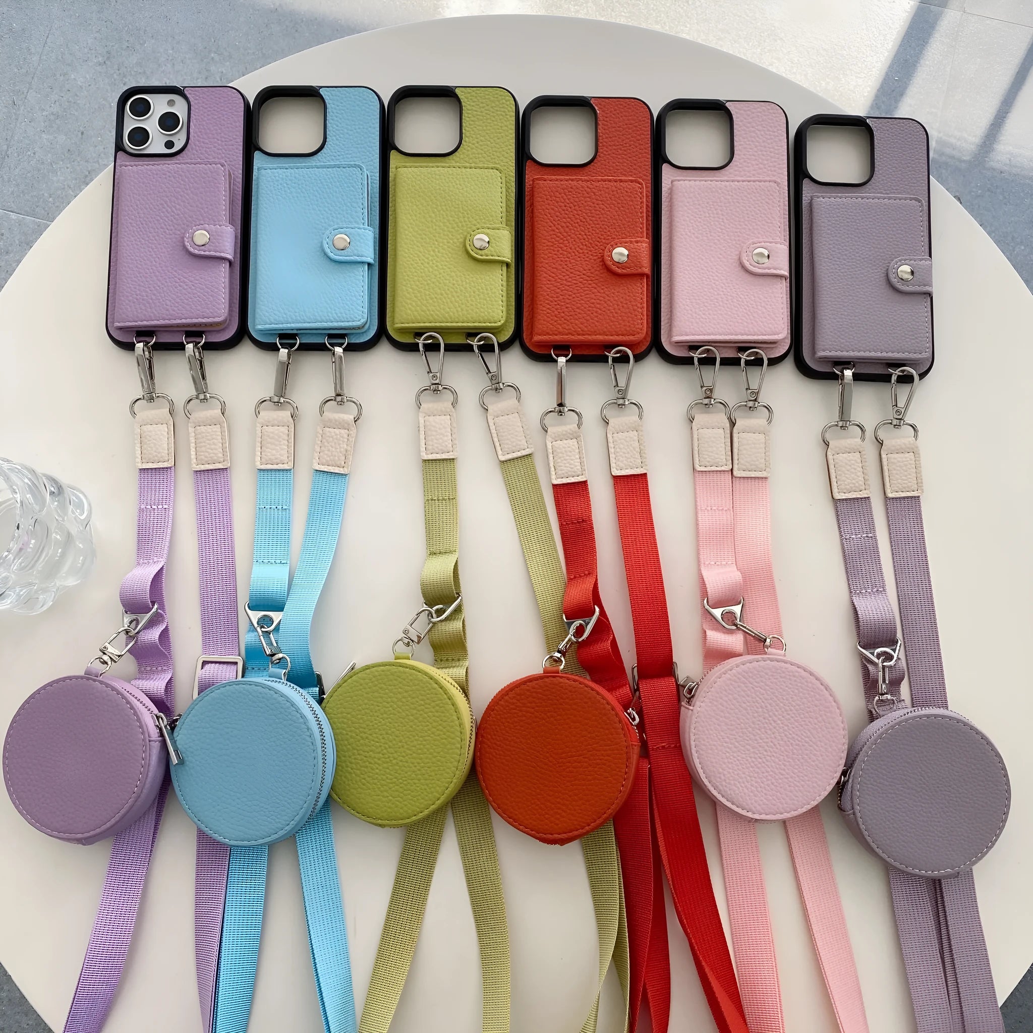 PC leather iPhone case with a card slot on the back and a lanyard loop, shown in multiple colours.
