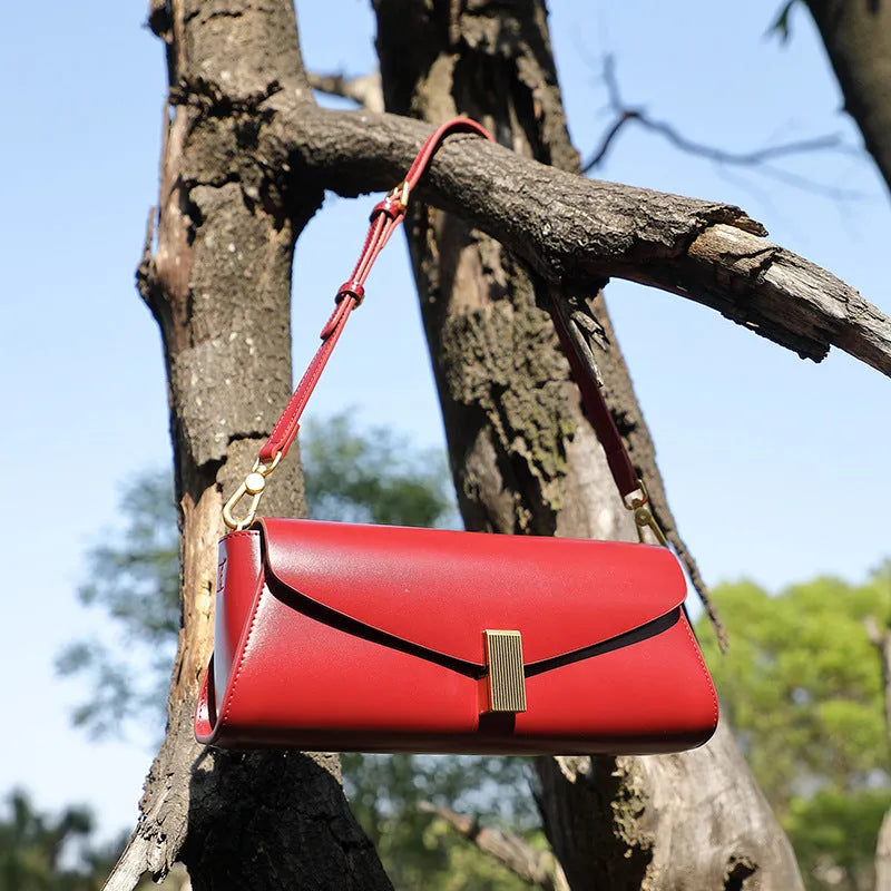 Women's cowhide leather cross-body bag in clamshell design with internal organisers