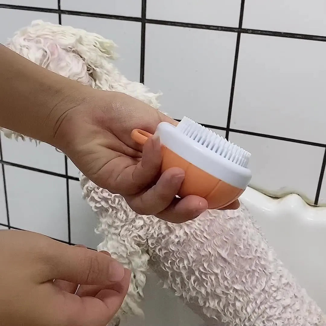 Orange silicone dog bath brush with shampoo dispenser and massage bristles for pet grooming