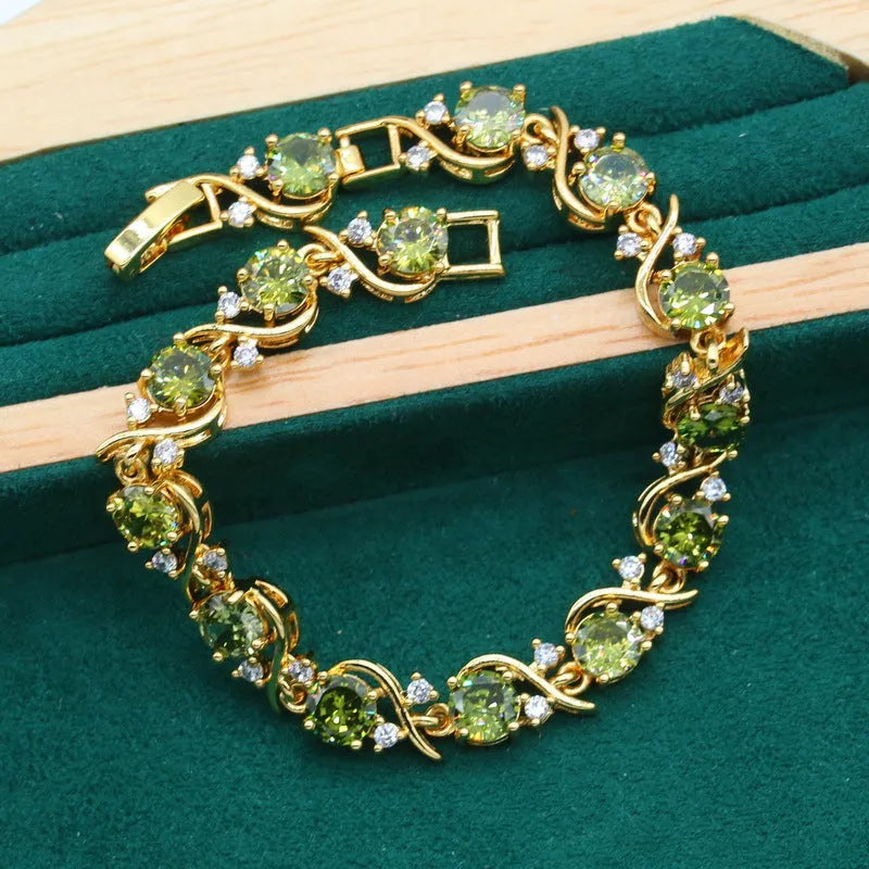 Olive green rhinestone zircon jewellery set with snake bone chain necklace, matching earrings, and ring.