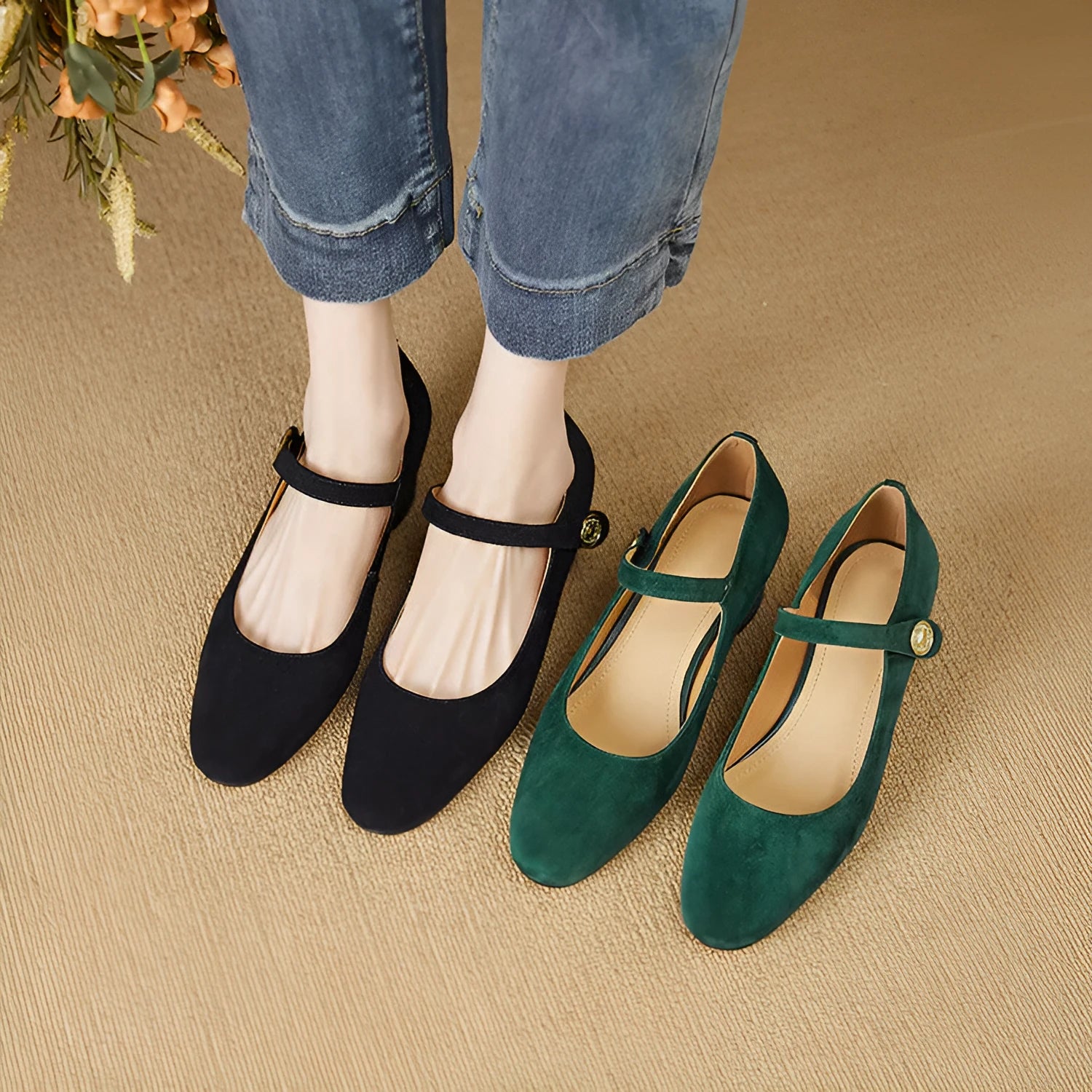 Women's black suede Mary Jane pumps with a chunky block heel and square toe on a plain background.