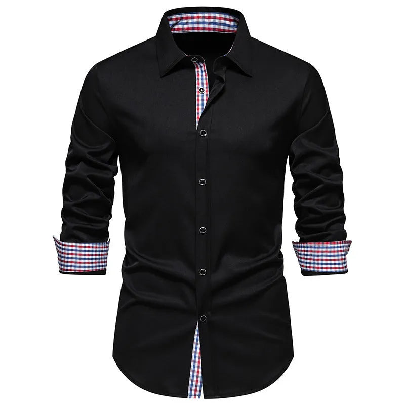 Man wearing a loose-fitting black and white plaid long-sleeved casual shirt.